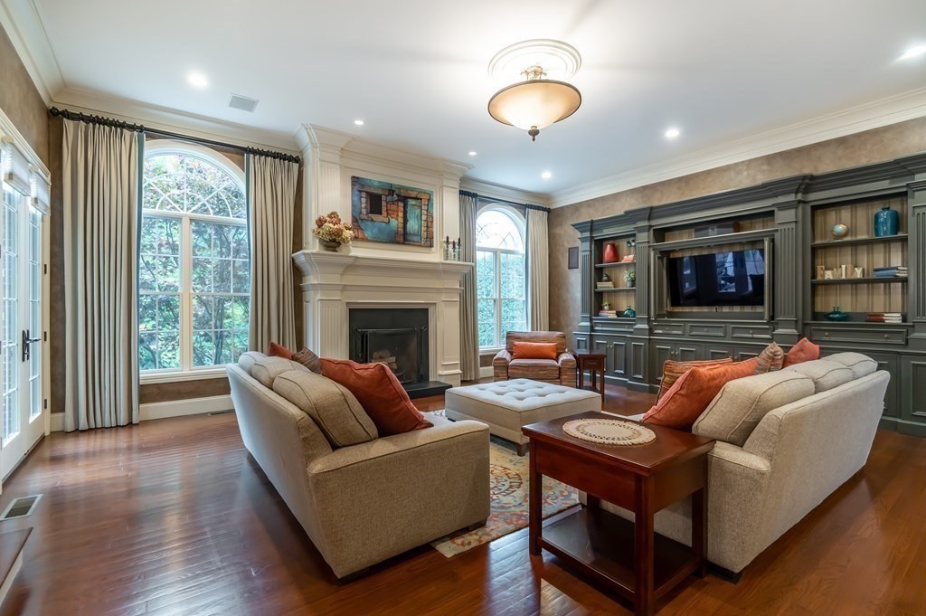 9 Prides Circle Andover, MA 01810 - Photo 17 of 42 a living room with furniture a fireplace and a flat screen tv