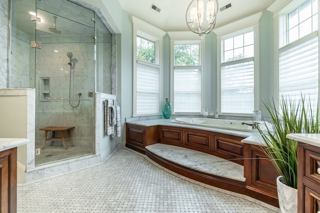 9 Prides Circle Andover, MA 01810 - Photo 24 of 42 a spacious bathroom with a granite countertop tub a sink and a large mirror