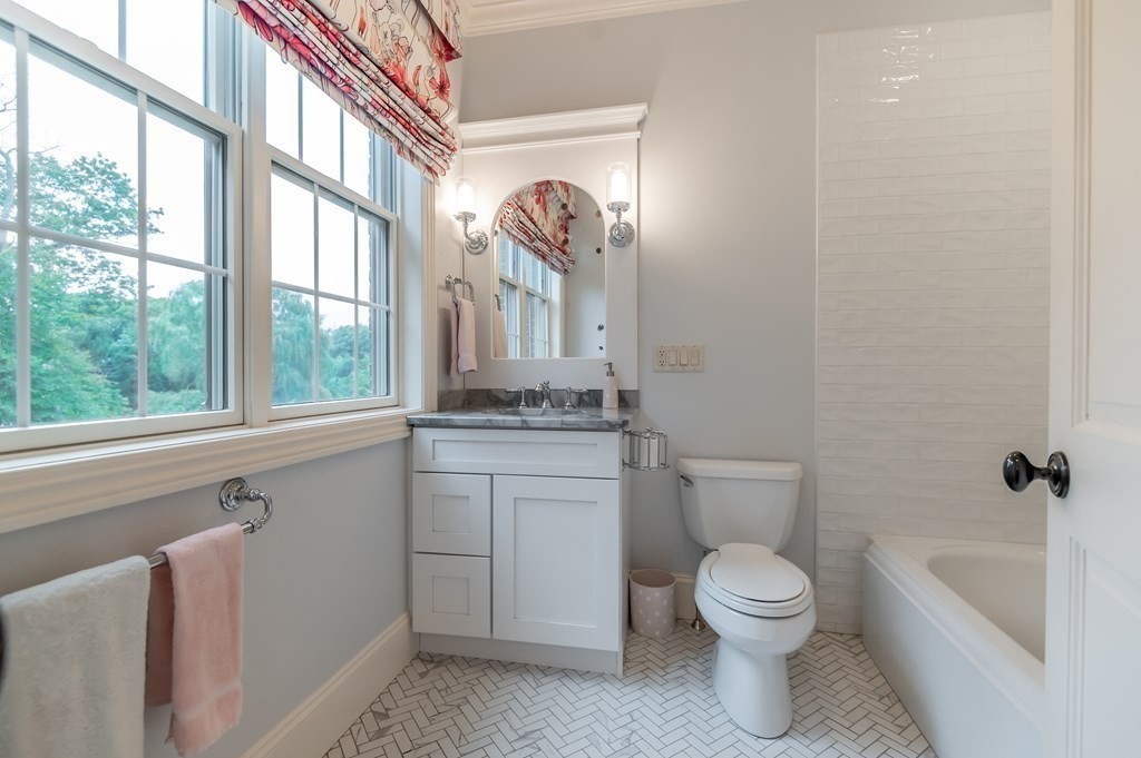 9 Prides Circle Andover, MA 01810 - Photo 28 of 42 a bathroom with a granite countertop toilet a sink and a bathtub