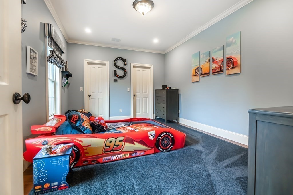 9 Prides Circle Andover, MA 01810 - Photo 29 of 42 a bedroom with a bed and a chandelier
