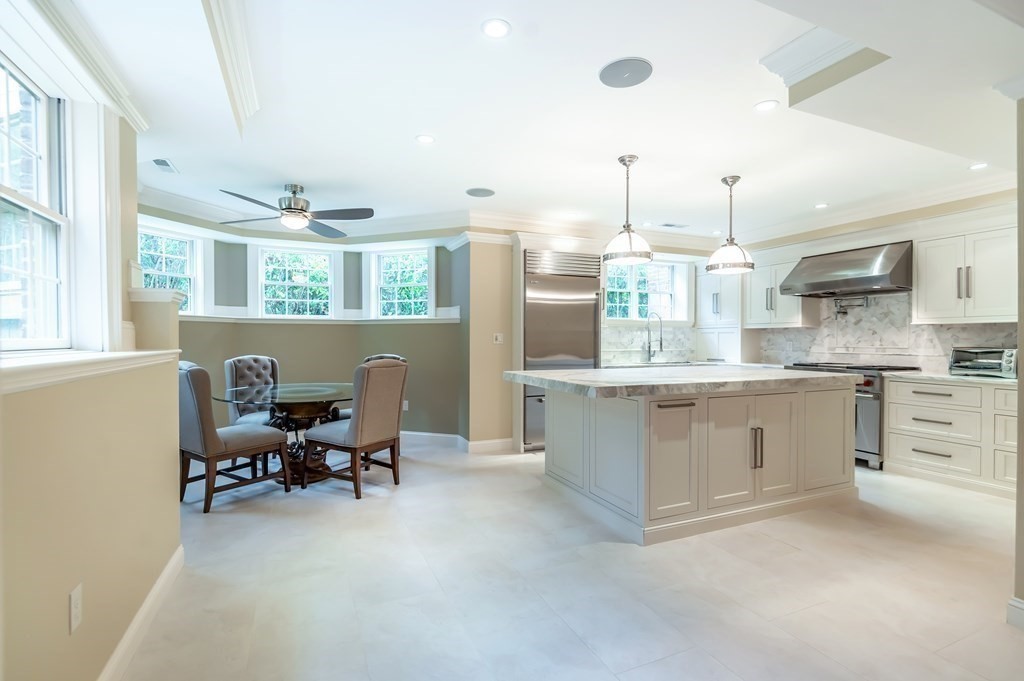 9 Prides Circle Andover, MA 01810 - Photo 34 of 42 a large kitchen with kitchen island a large counter space appliances and a window