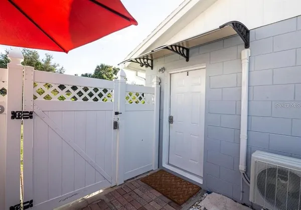 a view of a door and wooden fence