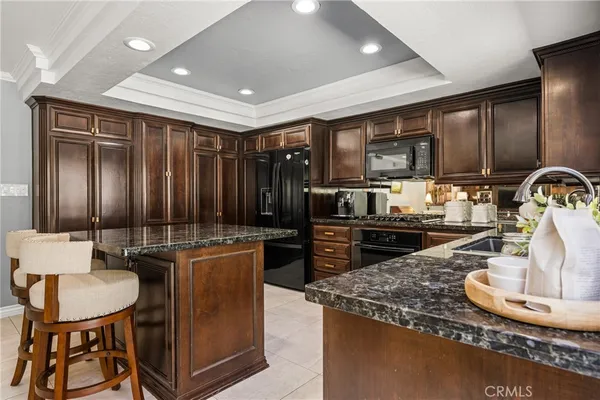 a kitchen with granite countertop a stove and a refrigerator