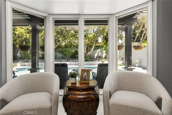 a living room with furniture potted plant and a large window