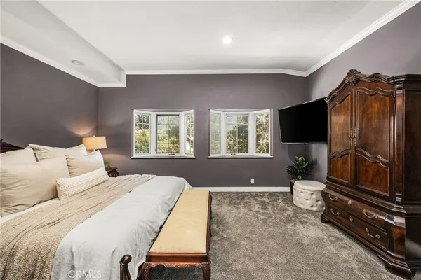 a bedroom with a bed lamps and window