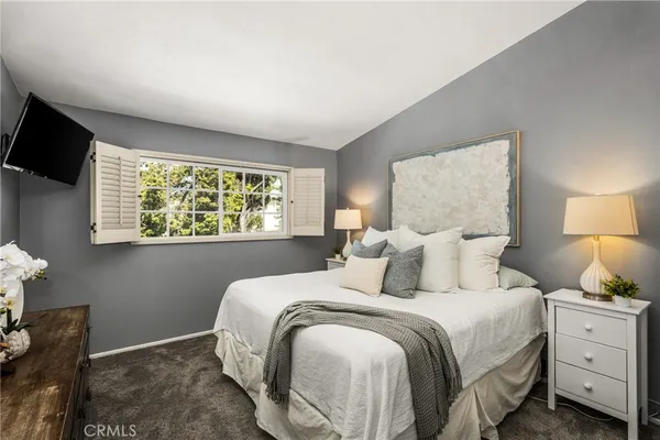 a bedroom with a bed and window
