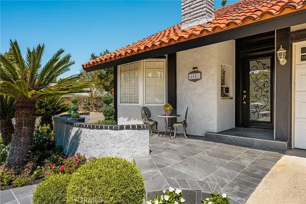 a view of a patio with table and chairs and potted plants