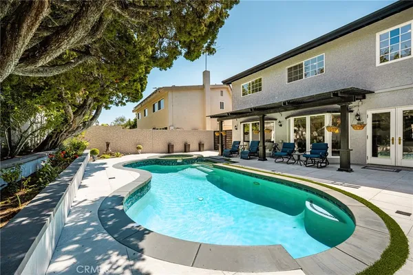 a view of a house with swimming pool and sitting area