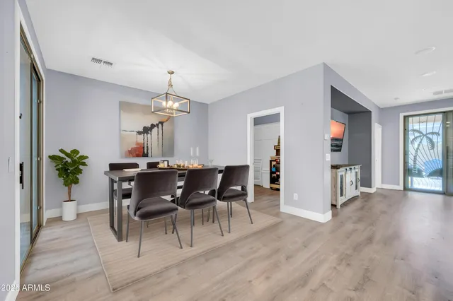 a living room with couches a fireplace and a flat screen tv