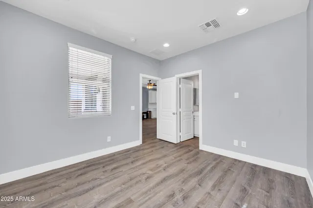 a view of a livingroom with a ceiling fan and window
