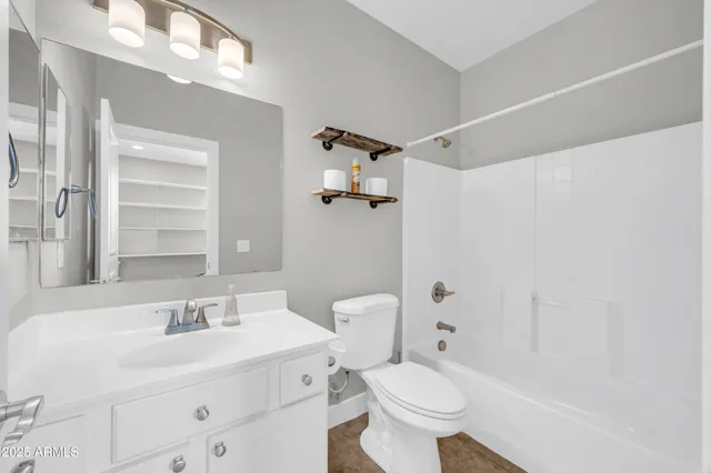 a living room with furniture and white walls