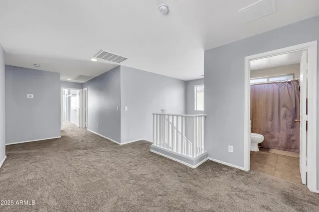 a spacious bathroom with a granite countertop sink mirror and shower