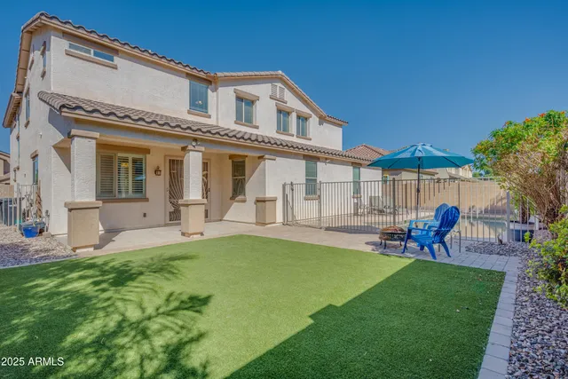 an aerial view of a swimming pool with outdoor seating