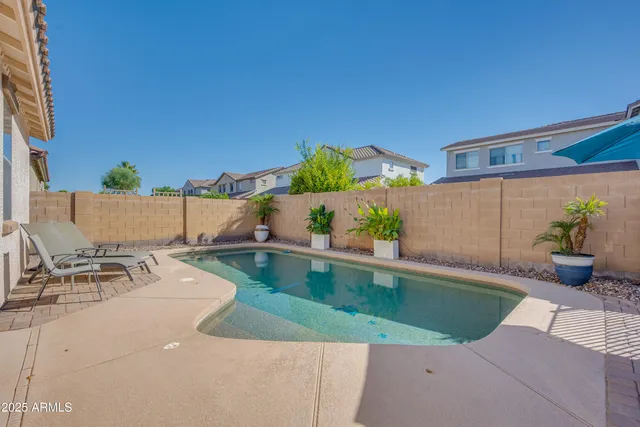 an aerial view of a house with a swimming pool