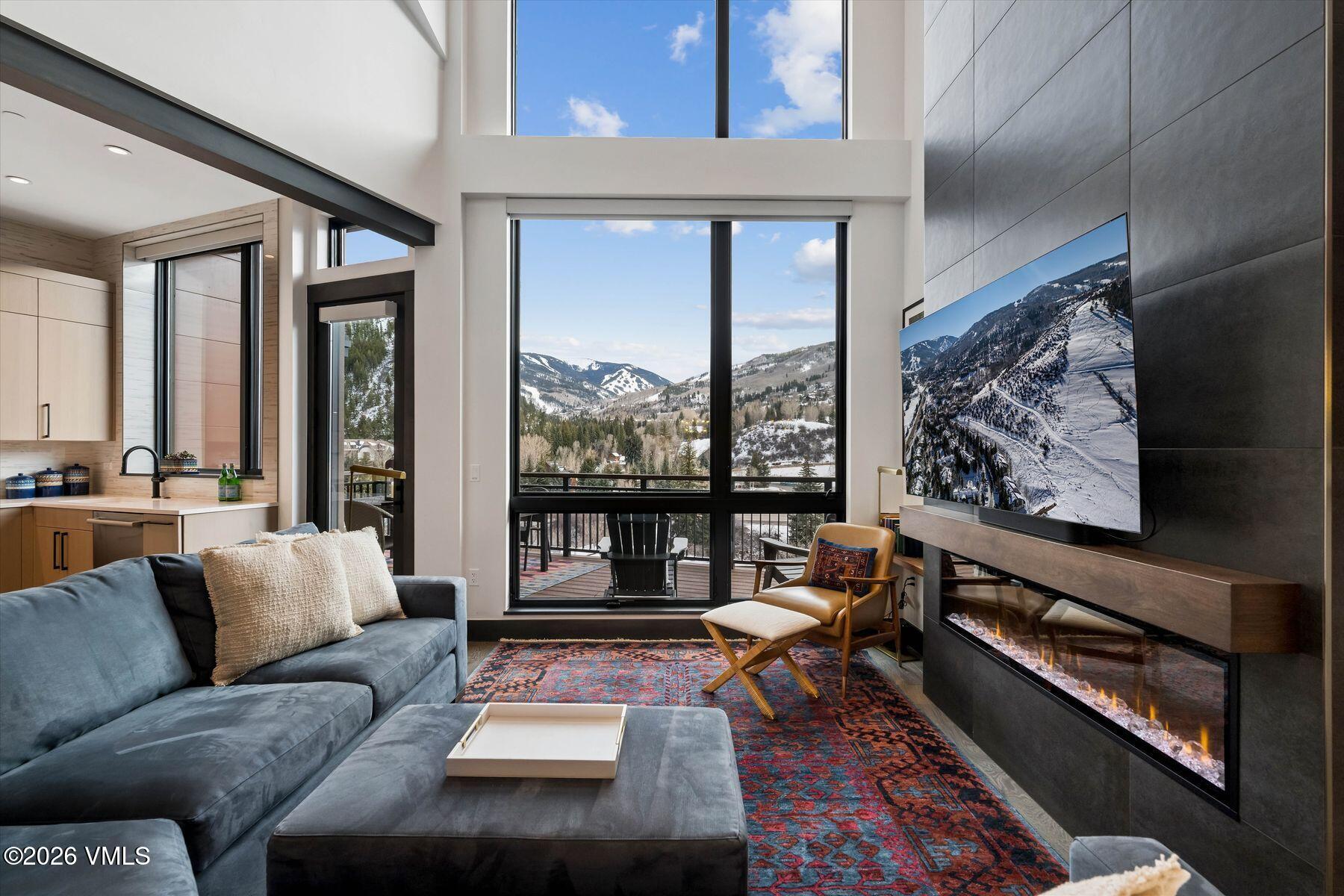 42 Riverfront Lane, Unit 508 Avon, CO 81620 - Photo 1 of 57 a living room with furniture and a floor to ceiling window