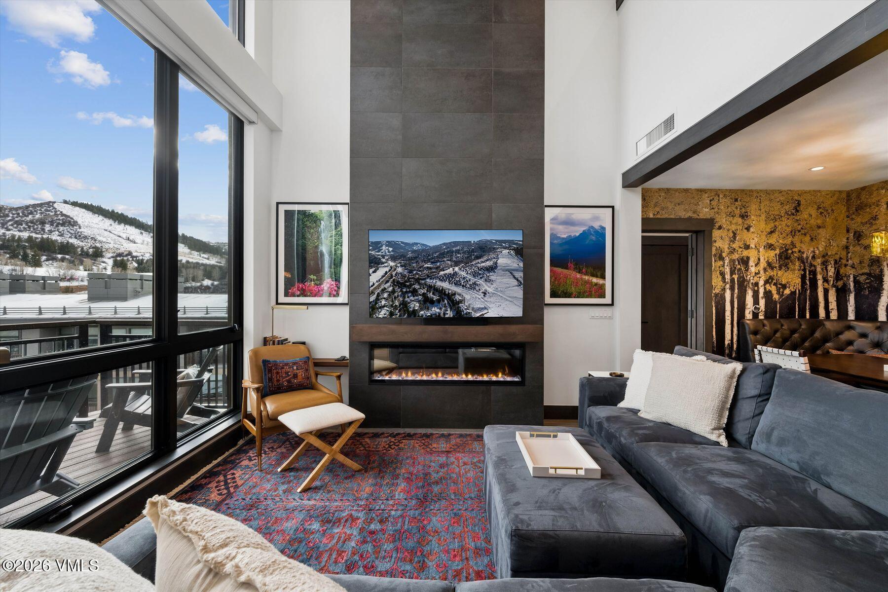 42 Riverfront Lane, Unit 508 Avon, CO 81620 - Photo 11 of 57 a living room with furniture a rug and a fireplace