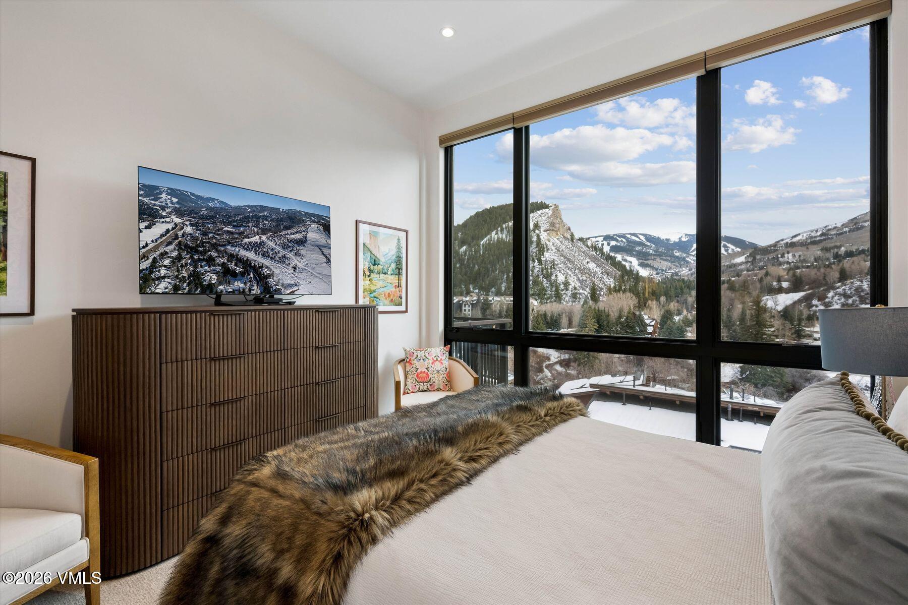 42 Riverfront Lane, Unit 508 Avon, CO 81620 - Photo 18 of 57 a bedroom with a bed and large window
