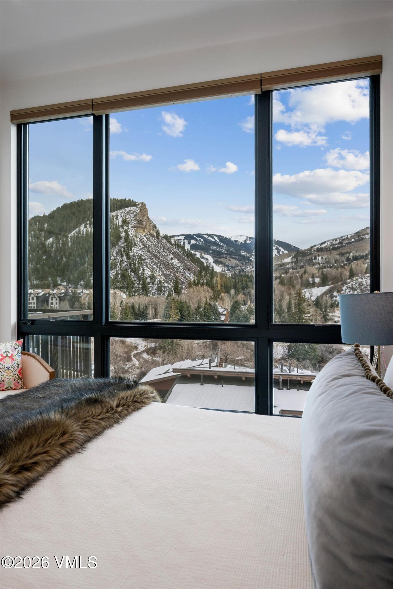 42 Riverfront Lane, Unit 508 Avon, CO 81620 - Photo 19 of 57 a view of a room with a large bed and a large window
