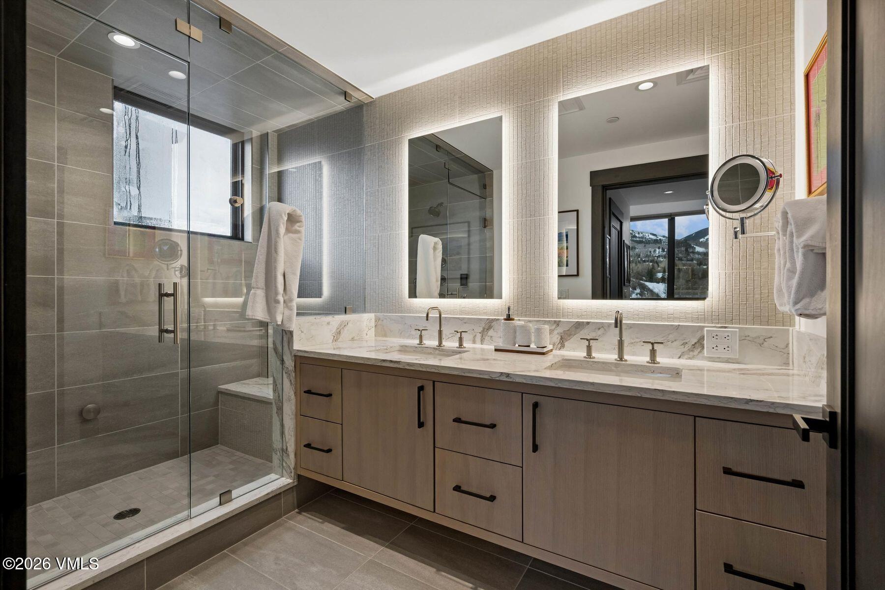 42 Riverfront Lane, Unit 508 Avon, CO 81620 - Photo 21 of 57 a bathroom with a double vanity sink mirror and shower