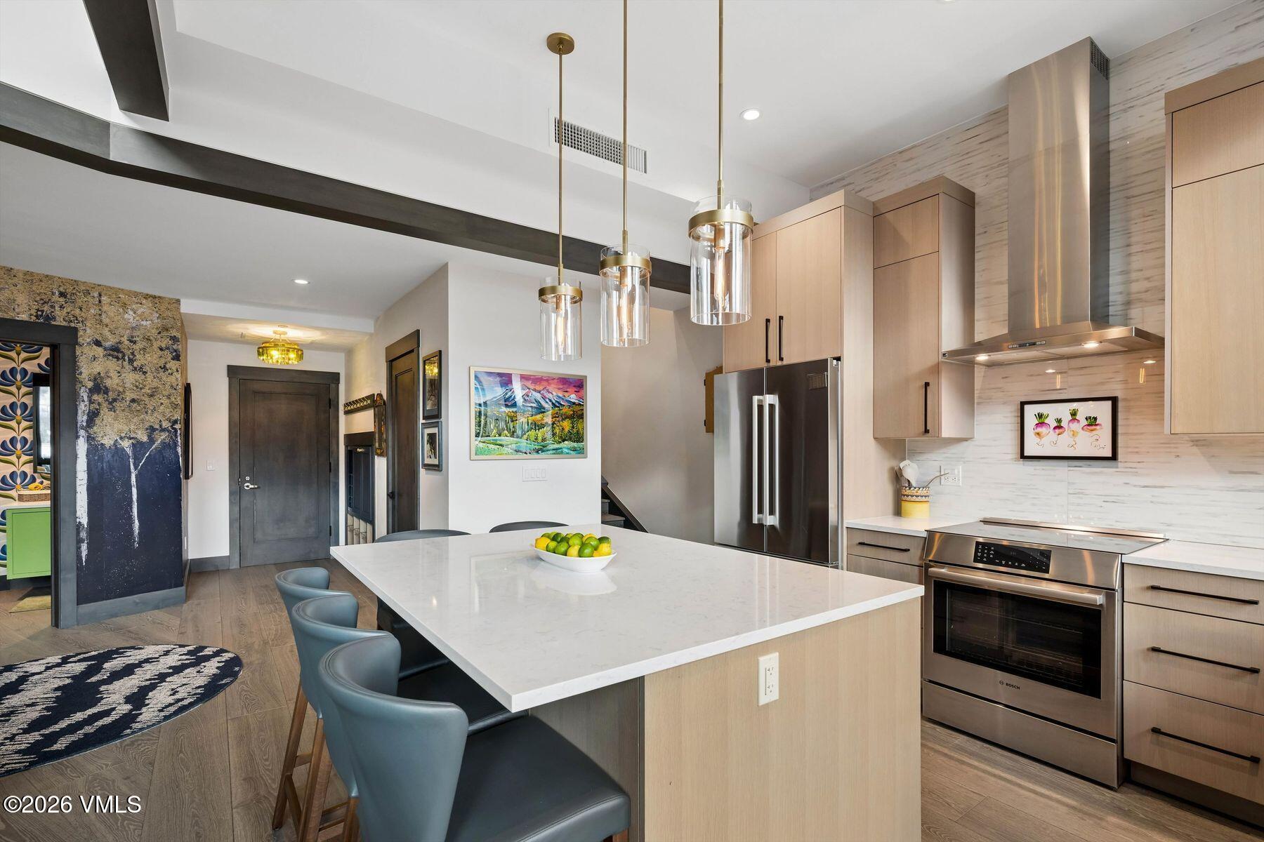 42 Riverfront Lane, Unit 508 Avon, CO 81620 - Photo 7 of 57 a kitchen with stainless steel appliances a stove a refrigerator and a refrigerator