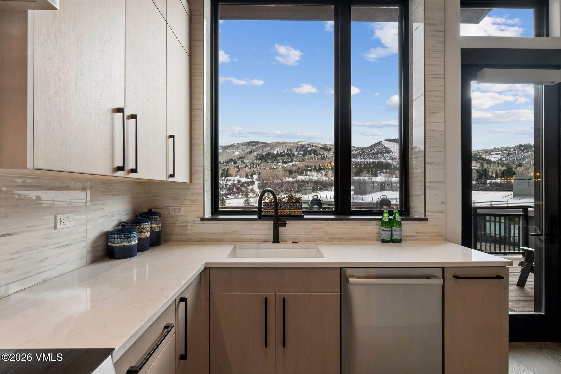 42 Riverfront Lane, Unit 508 Avon, CO 81620 - Photo 9 of 57 a kitchen with sink a window and a refrigerator