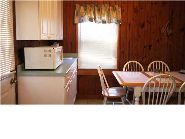 160 Pompano Street Inlet Beach, FL 32461 - Photo 6 of 11 a kitchen with a sink a window and furniture