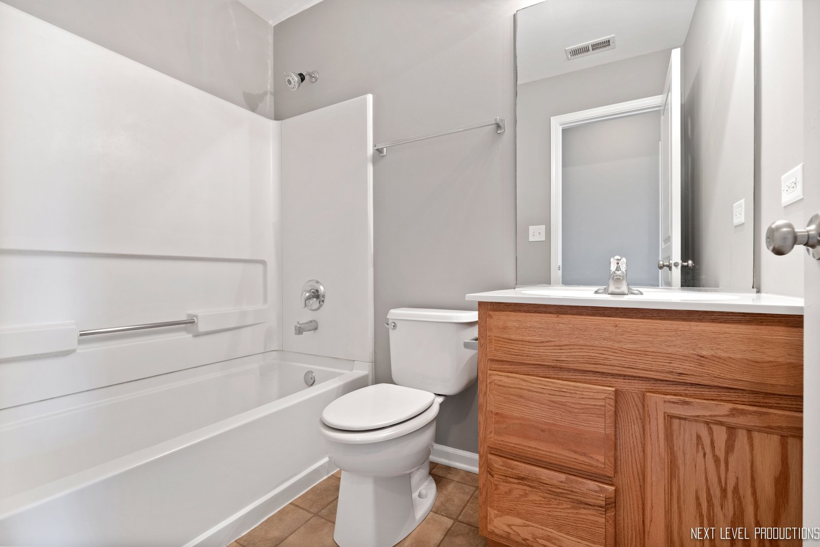 533 Metropolitan Street Aurora, IL 60502 - Photo 13 of 18 a bathroom with a sink a toilet and shower