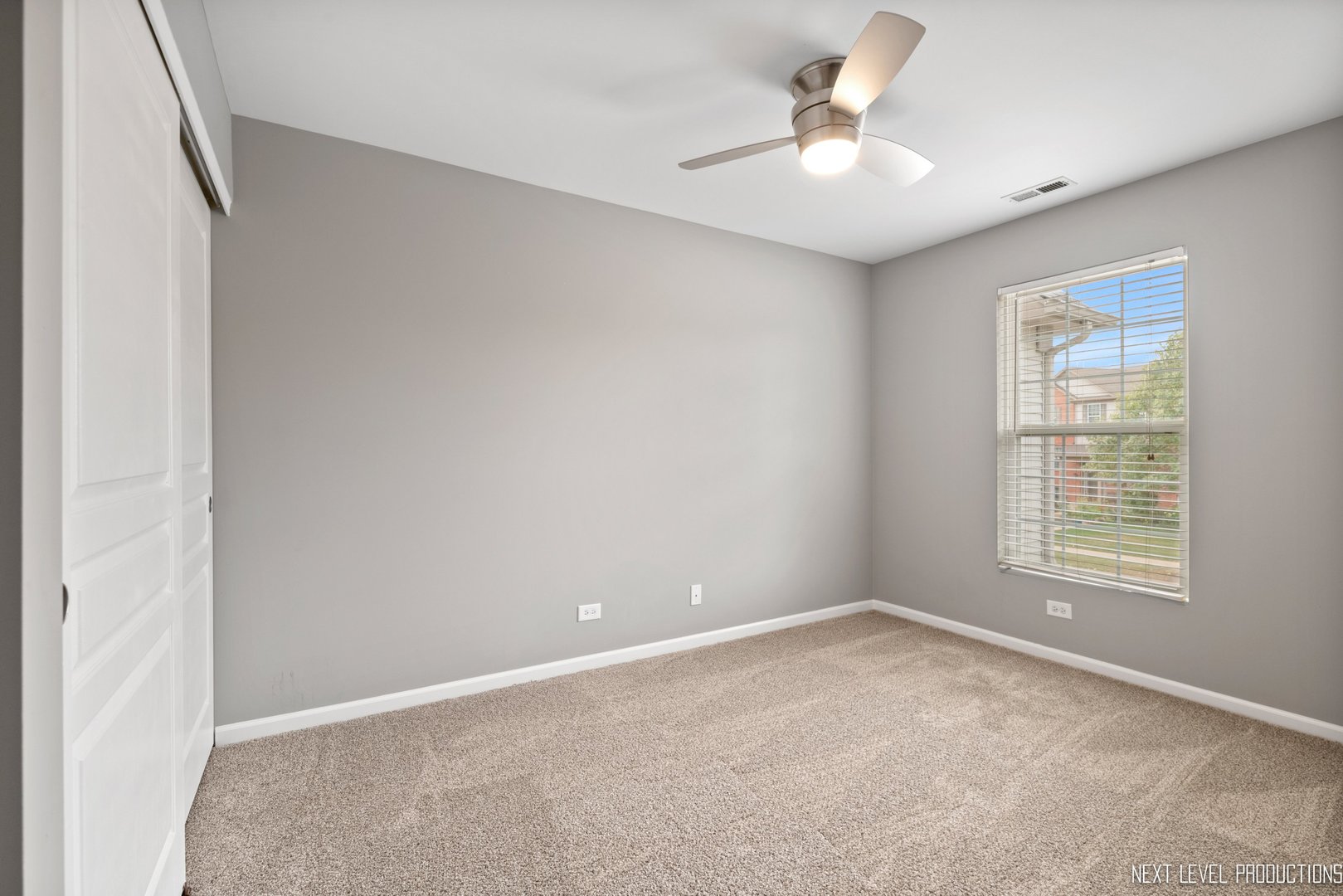 533 Metropolitan Street Aurora, IL 60502 - Photo 14 of 18 an empty room with windows and ceiling fan