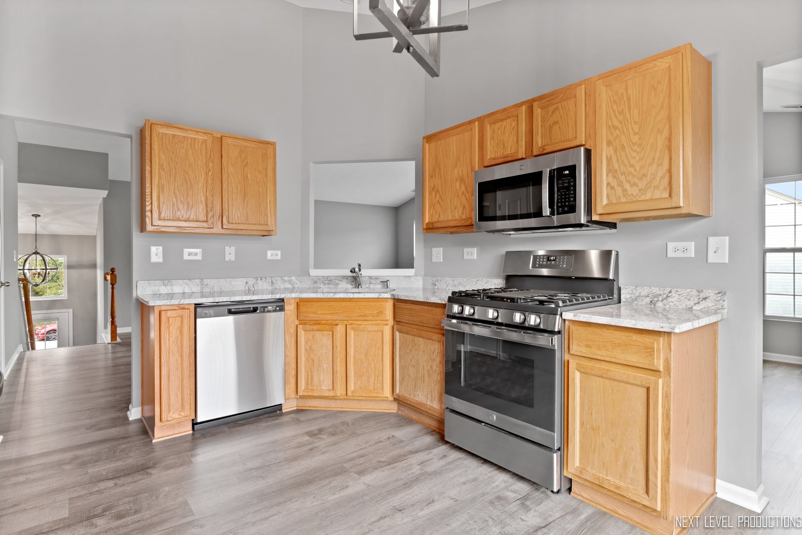 533 Metropolitan Street Aurora, IL 60502 - Photo 6 of 18 a kitchen with stainless steel appliances granite countertop a stove and a sink