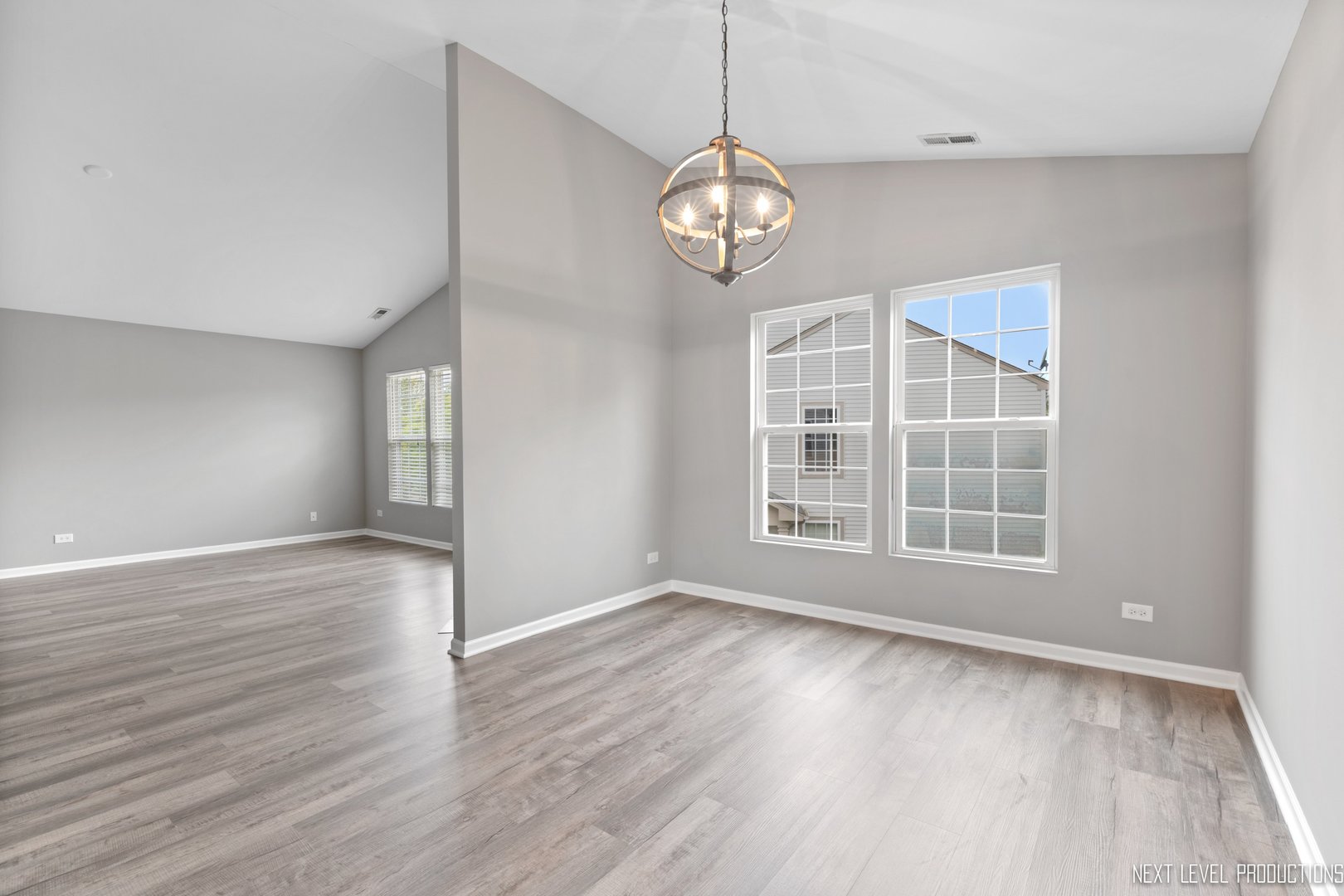 533 Metropolitan Street Aurora, IL 60502 - Photo 8 of 18 an empty room with wooden floor and windows