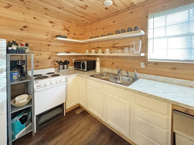 a kitchen with cabinets and window