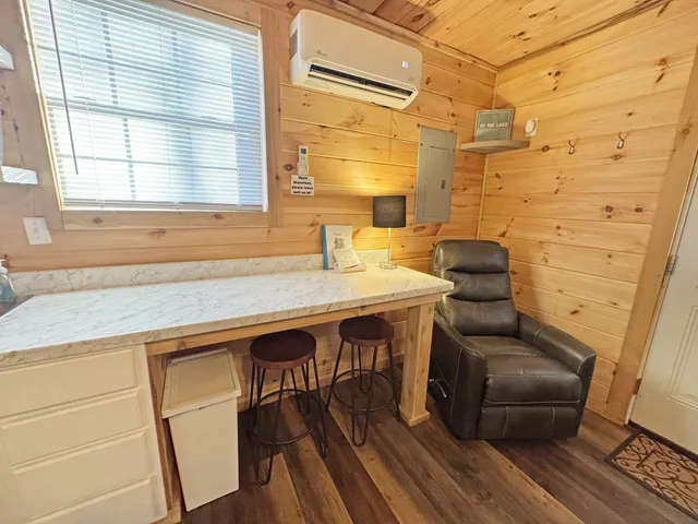 a dining room with furniture and wooden floor