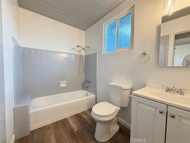 a bathroom with a toilet a sink and bathtub