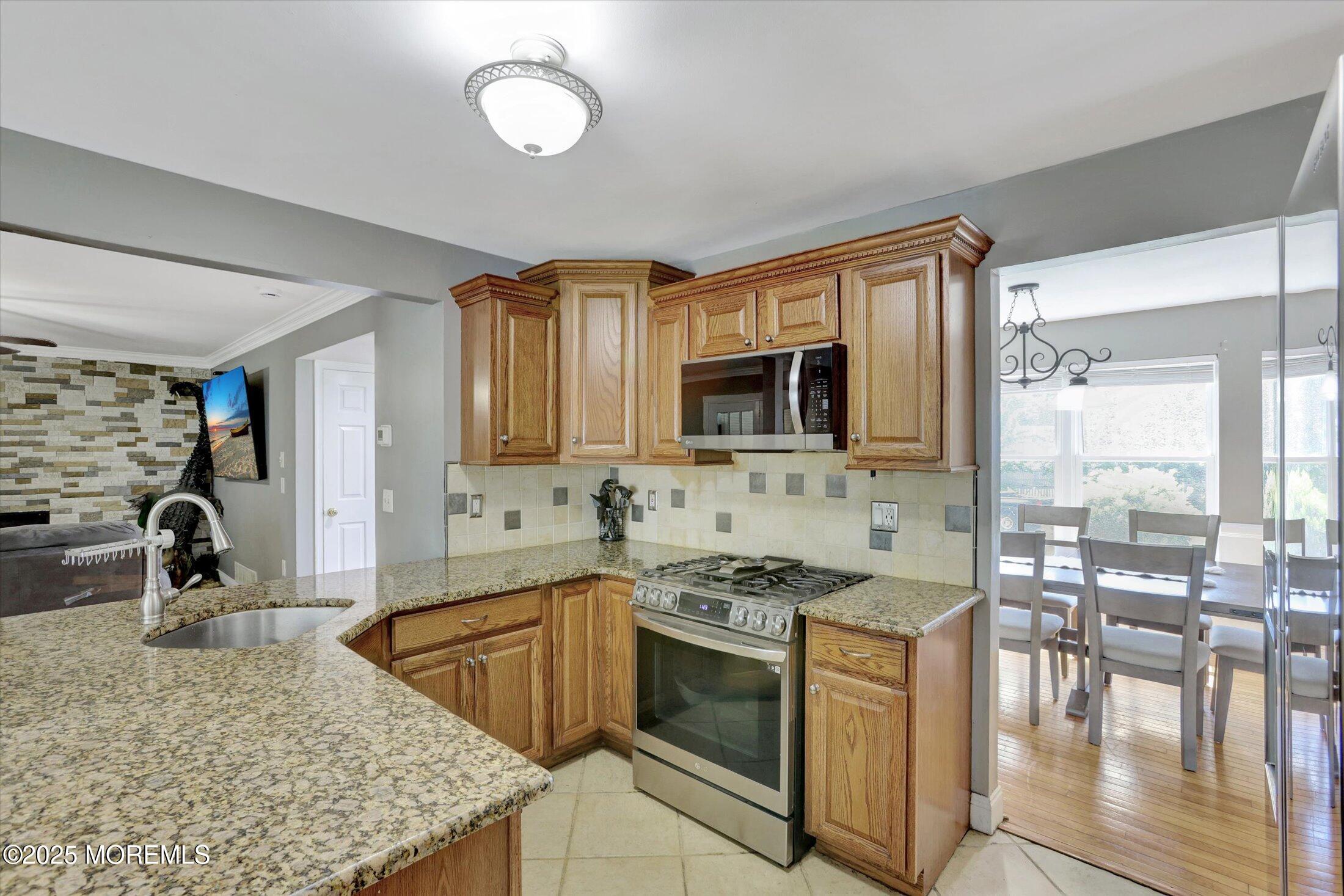 8 Shadow Ridge Court Howell, NJ 07731 - Photo 13 of 39 a kitchen with stainless steel appliances granite countertop a sink stove and cabinets