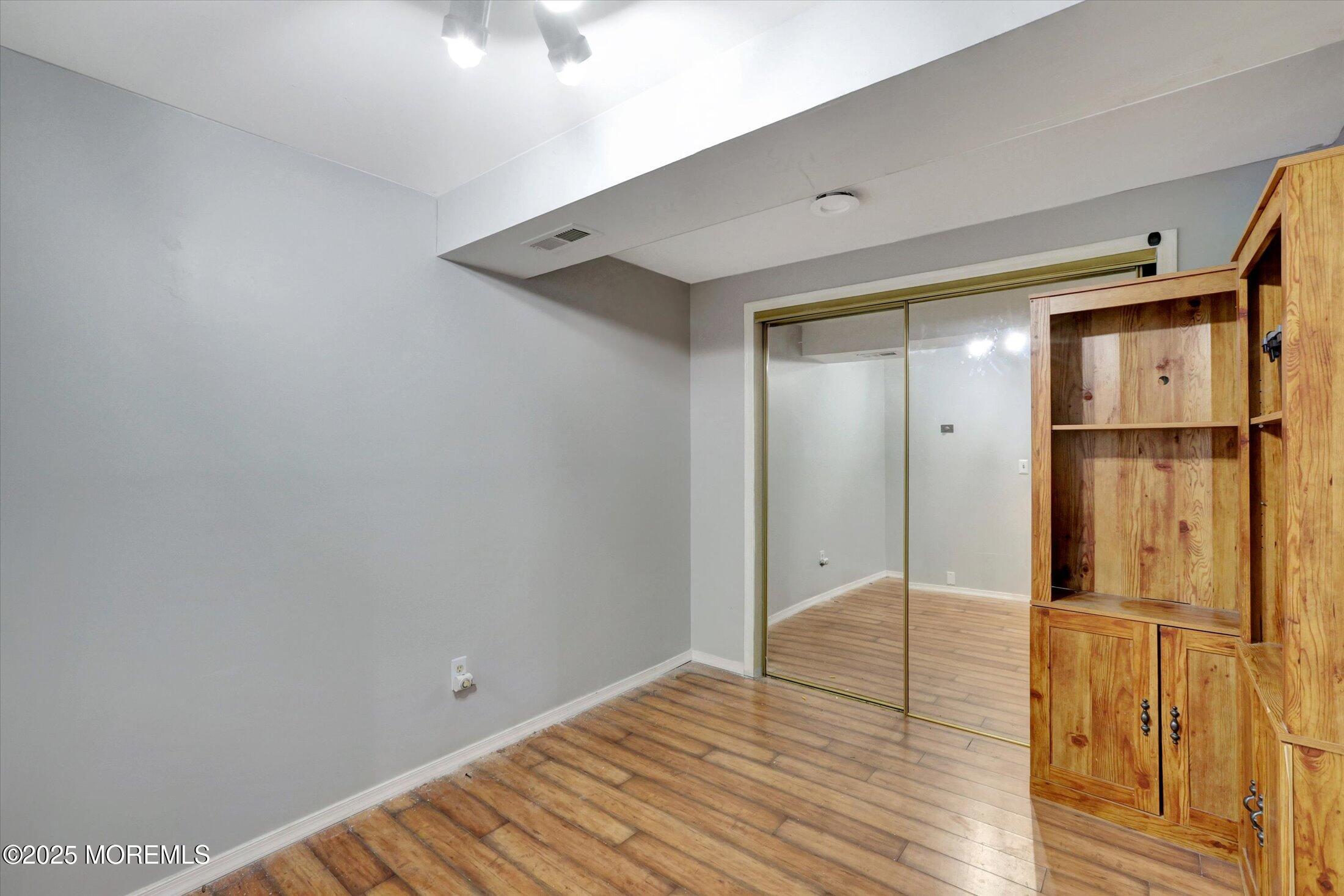 8 Shadow Ridge Court Howell, NJ 07731 - Photo 29 of 39 a view of empty room with wooden floor