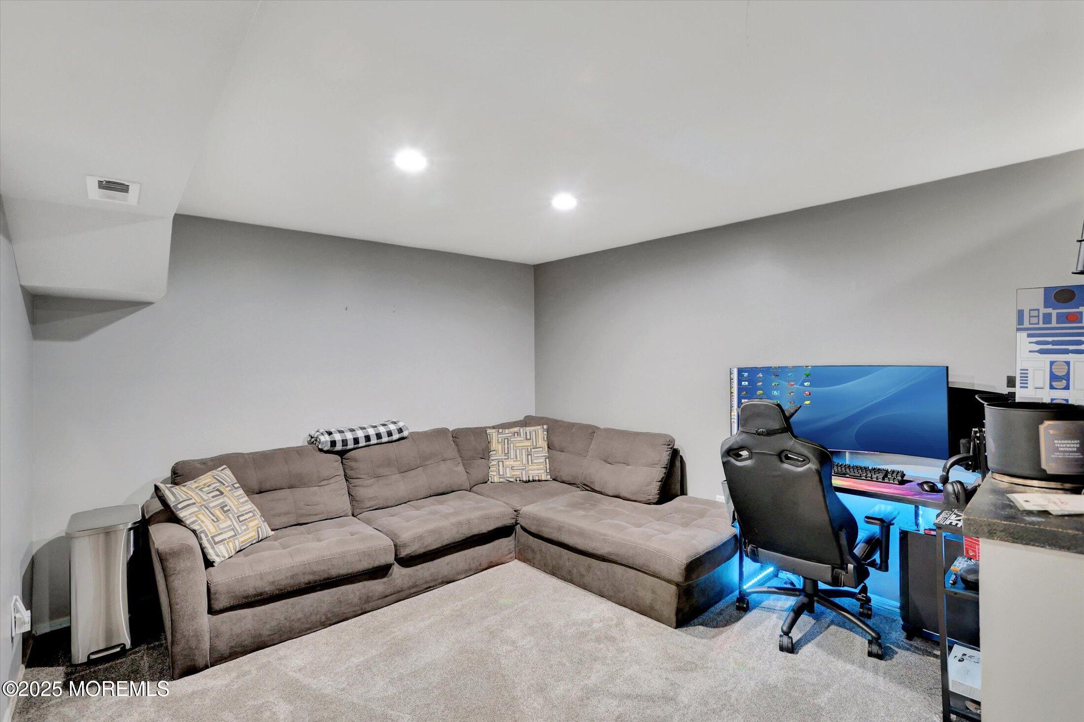 8 Shadow Ridge Court Howell, NJ 07731 - Photo 31 of 39 a living room with furniture and a flat screen tv