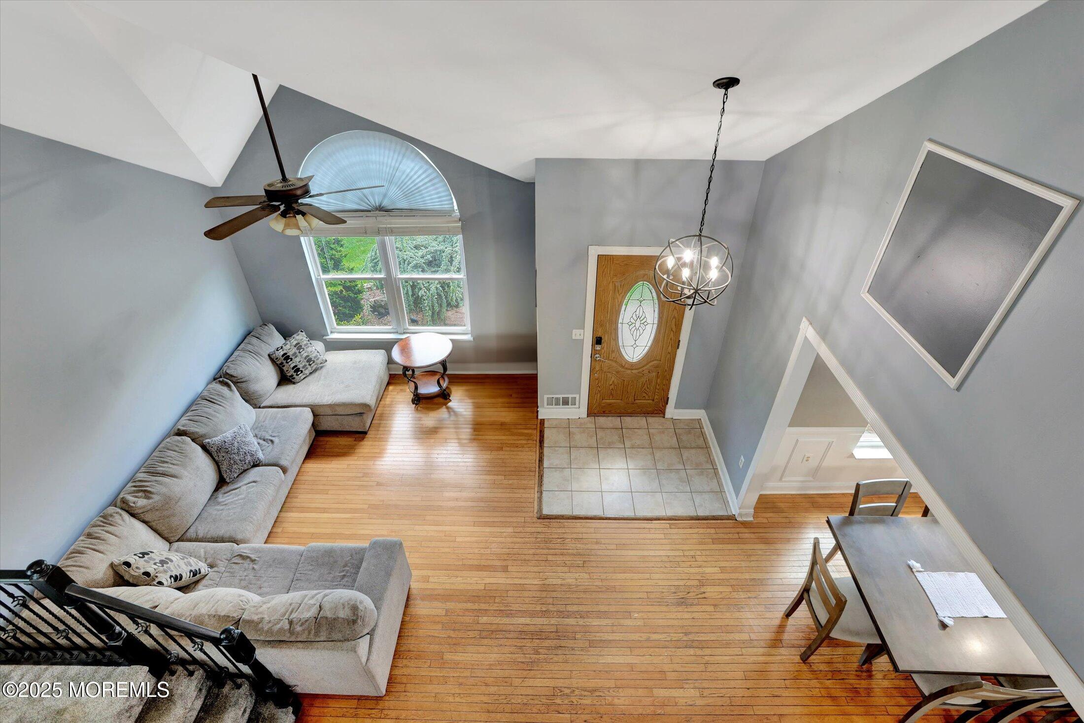 8 Shadow Ridge Court Howell, NJ 07731 - Photo 6 of 39 a living room with couches painting on the wall and a floor to ceiling window