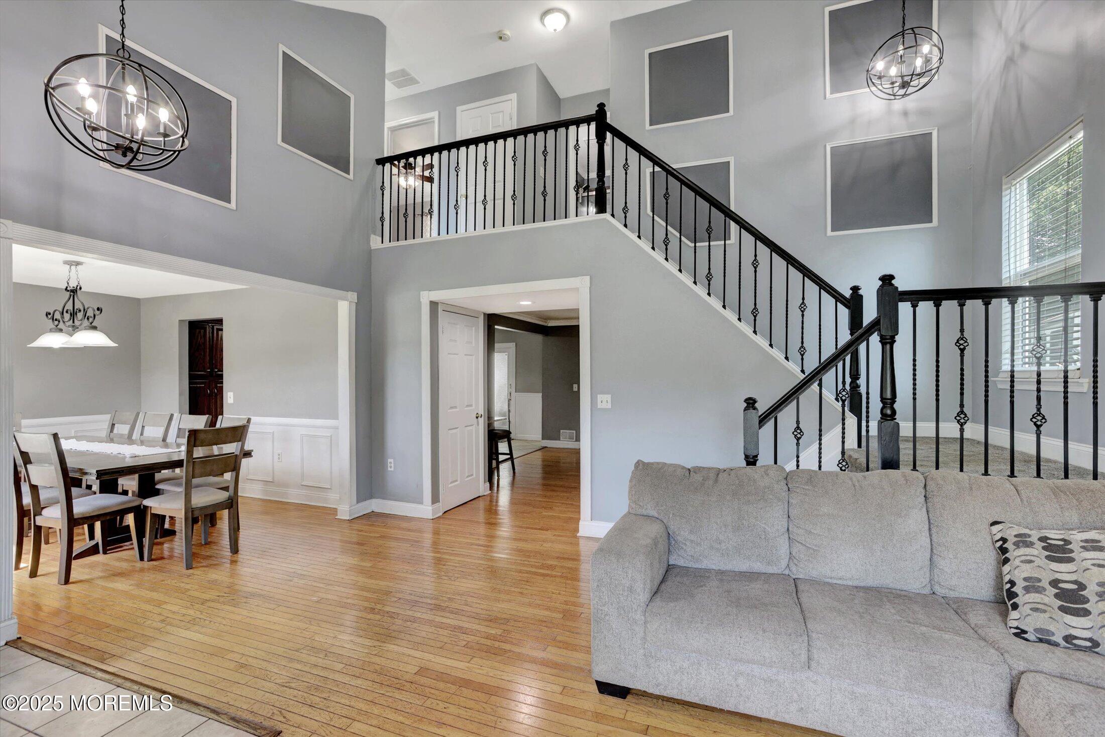 8 Shadow Ridge Court Howell, NJ 07731 - Photo 7 of 39 a living room with furniture and a chandelier