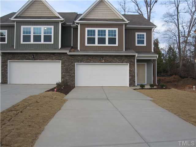 807 Davidson Point Road Cary, NC 27513 - Photo 1 of 1 a front view of a house with a garage and large trees