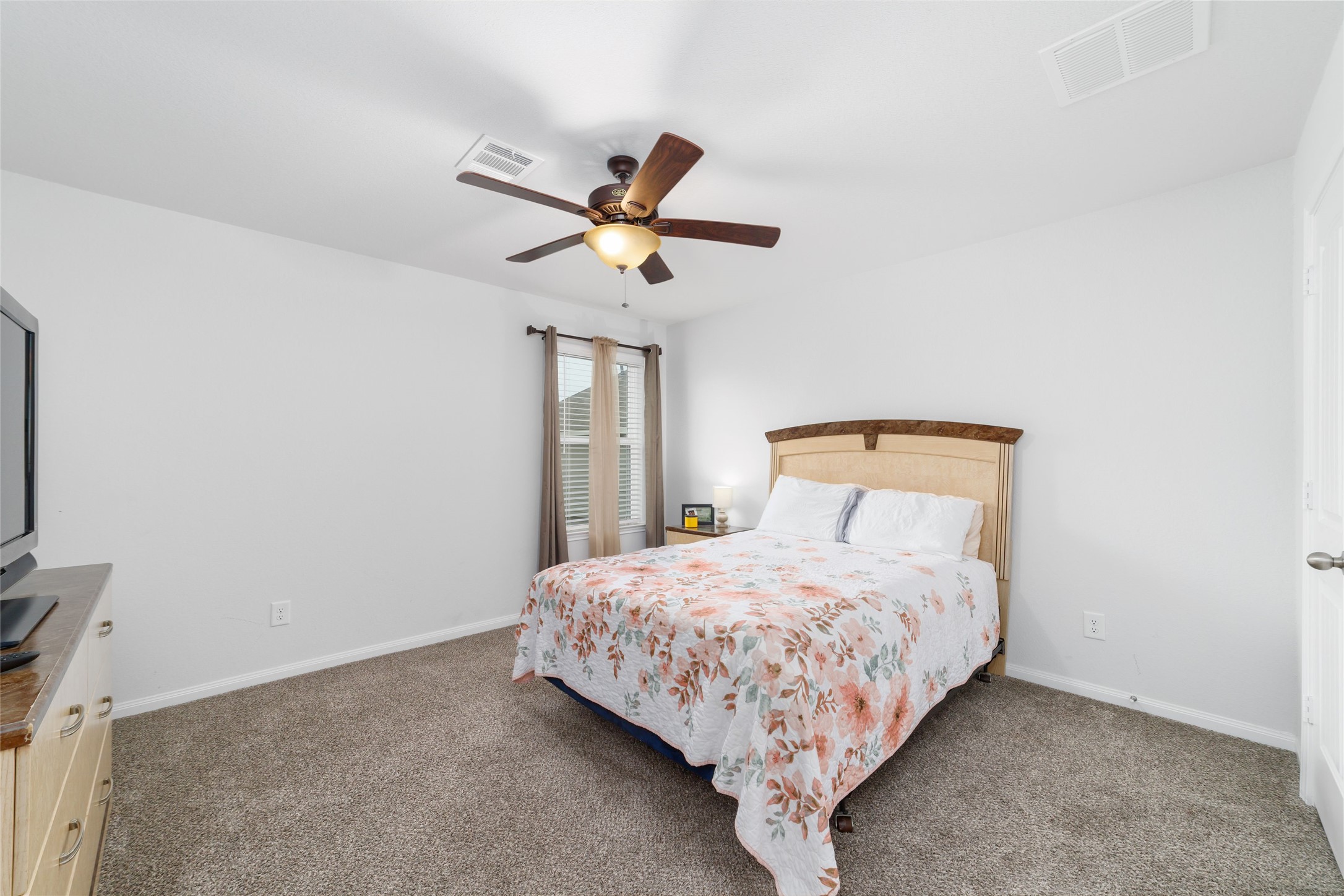 18619 Cooper Ravine Way Katy, TX 77449 - Photo 20 of 23 a bedroom with a bed and a window