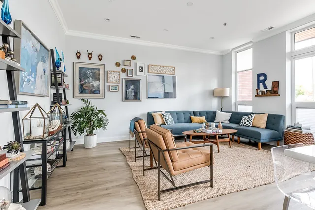 a living room with furniture and wooden floor