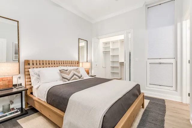 a spacious bedroom with a bed and a window