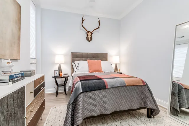 a bedroom with a bed and wooden floor