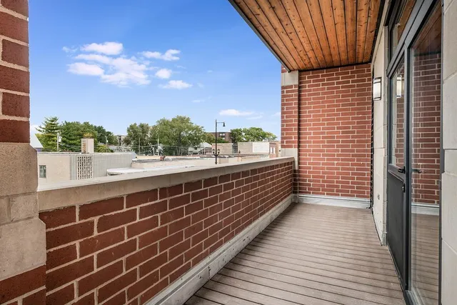 a view of balcony with wooden floor and city view