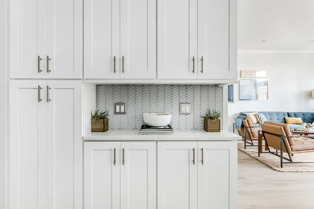 a kitchen with white cabinets