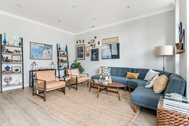 a living room with furniture and a lamp