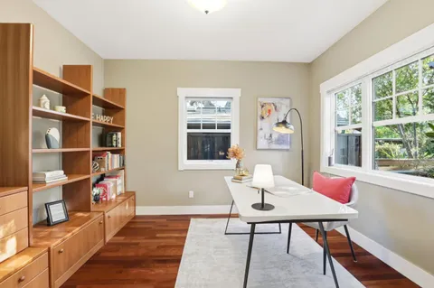 a workspace with furniture window and wooden floor