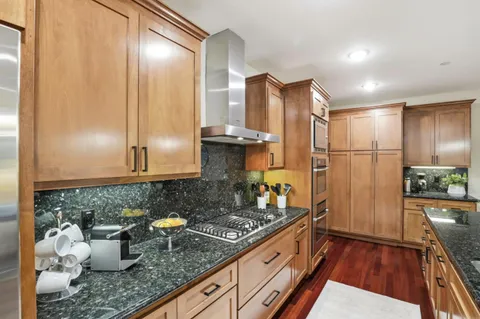a kitchen with sink refrigerator and stove