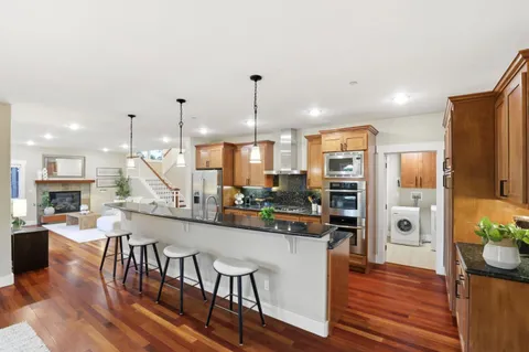 a large kitchen with a table and chairs