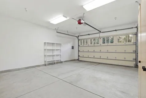 a patio with table and chairs and potted plants